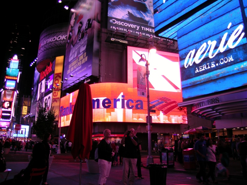 building exterior, city lights, nigh, leisure activity, architecture, broadway, group of people, lifestyles, advertisement, crowd, walking, sign, night view