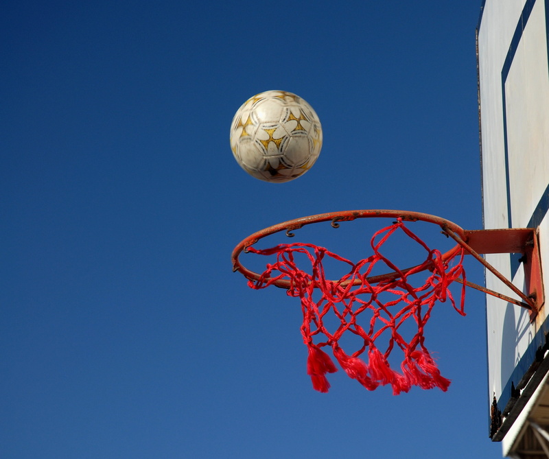 sunlight, clear sky, day, net - sports equipment, ball, shape, sphere, blue, low angle view, no people, basketball, sunny, copy space, sport, mid-air, nature