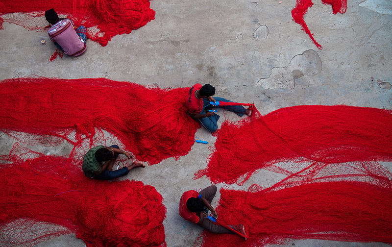 fishing, adult, work space, floor, four, red, working, full length, life, thread, high angle view, colour, sport, art and craft, people, group, lifestyles