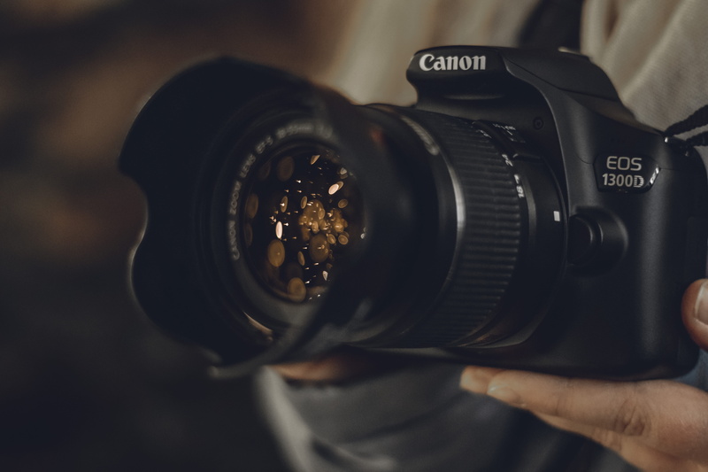 bokeh, lens - optical instrument, hand, eos, modern, photographic equipment, one person, 1300d, human hand, retro styled, photographing, holding, black