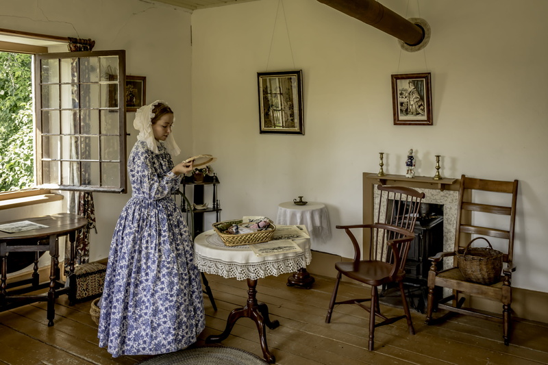settler, 5K, front, real people, woman, standing, table, one person, pedestal, young adult, room, lifestyles, furniture, day, seat, full length, embroidery