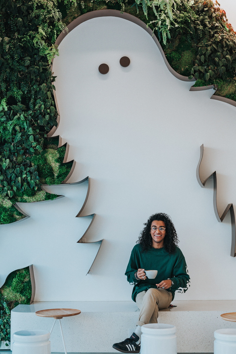 real people, one person, portrait, happiness, sweatshirt, pants, females, lifestyles, crew, outdoors, man, men, male, sitting, emotion, adult, coffe shop
