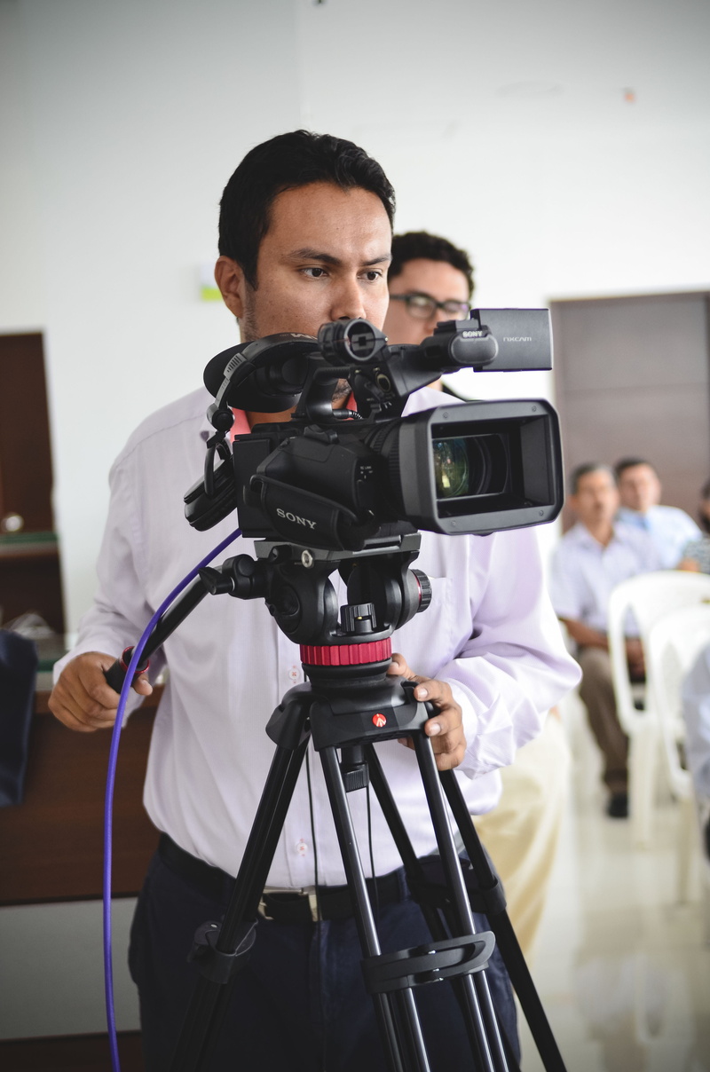 camera operator, Post-Production, Video, indoors, photographer, photography themes, real people, digital camera, technology, focus on foreground, photographic equipment