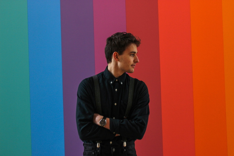 brown hair, profile view, confidence, waist up, unknown, wall - building feature, front view, looking away, young adult, adult, 5K, male, indoors, colored background