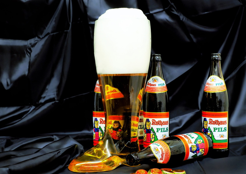 group of objects, safety, food and drink, alcohol, textile, representation, beer boots, outdoors, celebration, black, drink, black background, brow, beer bottle
