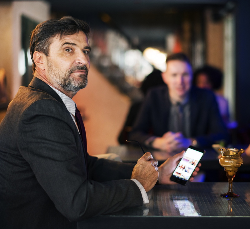adult, mature adult, messaging, blond hair, american, glass, beard, facial hair, men, well-dressed, sitting, ceo, feed, incidental people, businesswoman