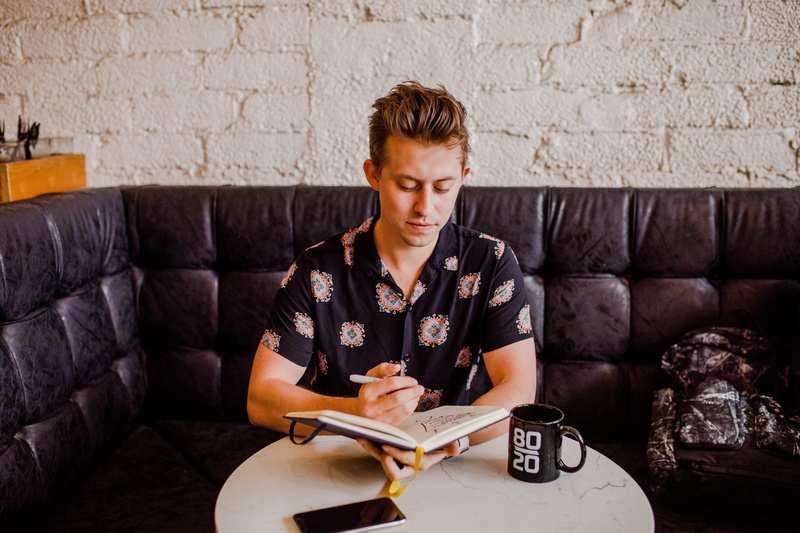 note pad, learning, living room, human, looking, front view, domestic room, blog, hairstyle, holding, desk, author, young adult, brick, investor, sofa