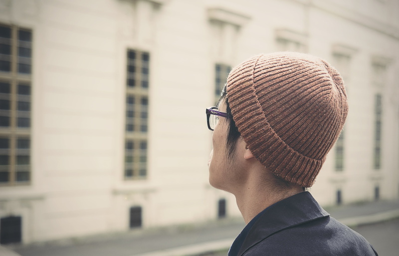 rear view, built structure, sunglasses, blur, one person, close-up, 4K, eyeglasses, building, hat, young adult, person, blurry, boy, beanie, cap, city