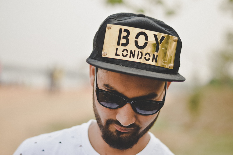 portrait, person, eyewear, male, outdoors, blur, text, sunglasses, one person, facial hair, wearing, facial expression, beard, photo, clothing, glasses
