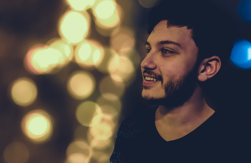young men, depth of field, nightlife, close-up, smiling, beard, young adult, focus, boy, illuminated, photoshoot, emotion, model, headshot, looking away