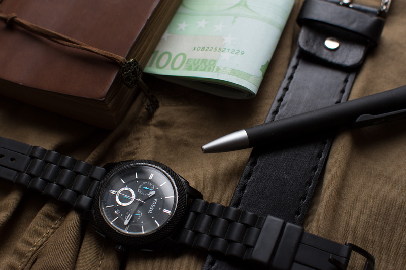 western script, book, text, close-up, round, group of objects, table, euro, banknote, belt, number, safety, technology, pen, chronograph, high angle view