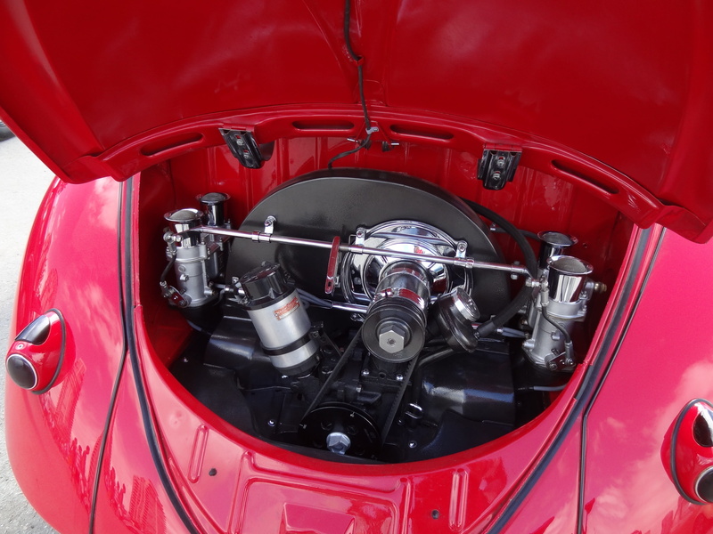 Motor, auto repair shop, vehicle part, shiny, tire, mode of transportation, Volkswagen, chrome, red, car engine, oil, day, silver colored, no people, technology