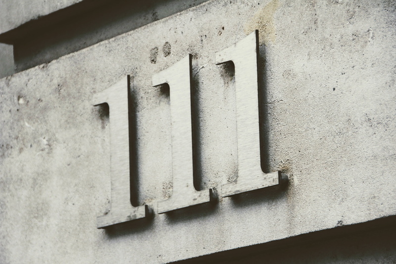 art and craft, text, outdoors, close-up, number, house number, metal, day, low angle view, shape, number code, 111, one hundred and eleven, wall - building feature