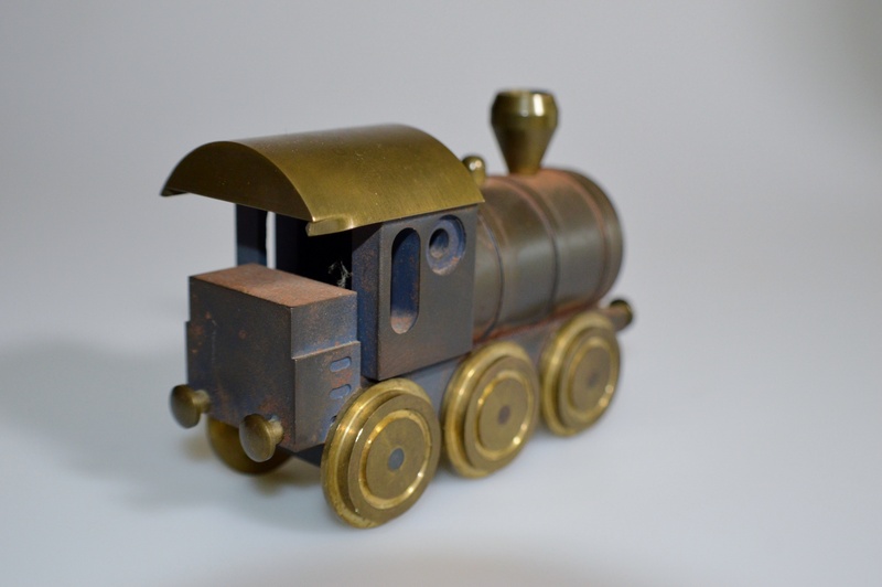 single object, locomotive, indoors, no people, finance, safety, studio shot, bankruptcy, cut out, object, brass, business, gray background, close-up, iron