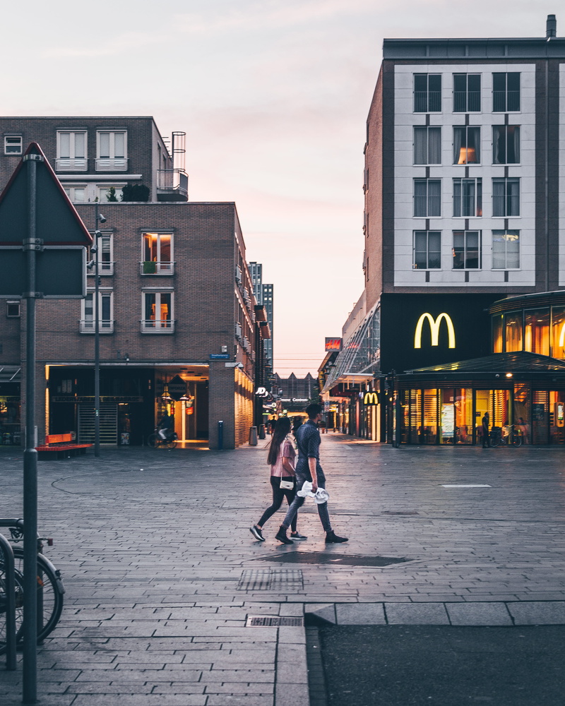 riding, walking, woman, man, building exterior, couple, real people, market, shops, stores, daylight, buildings, building, travel, street, sky, day, leisure activity