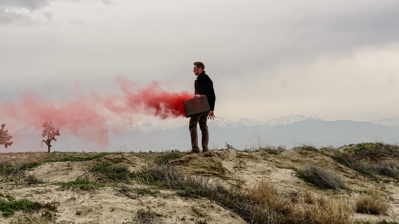 cliff, one person, smoke - physical structure, briefcase, suit, mountain, standing, business, red, environment, full length, day, man, men, smoke, edge