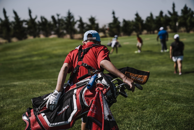 man, tournament, heavy, carrying, carry, athlete, clothing, riding, plant, sports clothing, competition, active, golf course, black, adult, outdoors, action