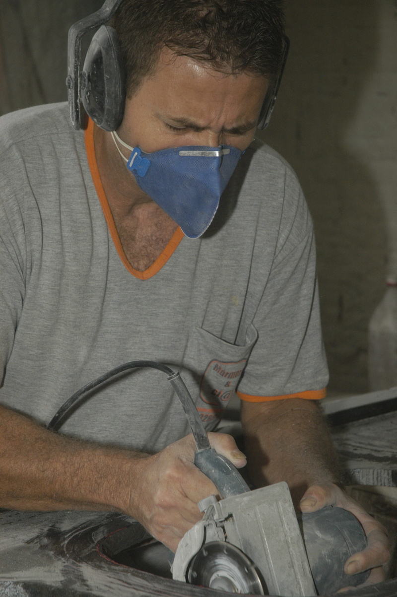 real people, looking, young men, marble, personal protection, repairing, young adult, concentration, whim, security, working, front view, one person, holding