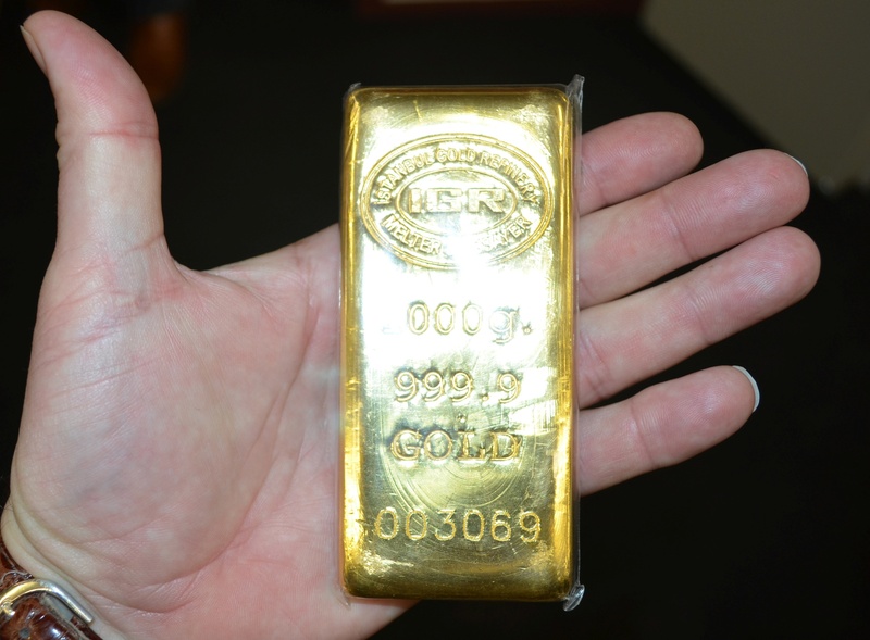 gold colored, unrecognizable person, close-up, golden, business, ingot, wealth, human body part, body part, hand, finance, holding, bullion, luxury, indoors