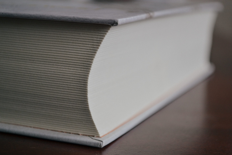 studio shot, close-up, selective focus, single object, indoors, simplicity, publication, dictionary, encyclopedia, old, stack, cover, technology, covers