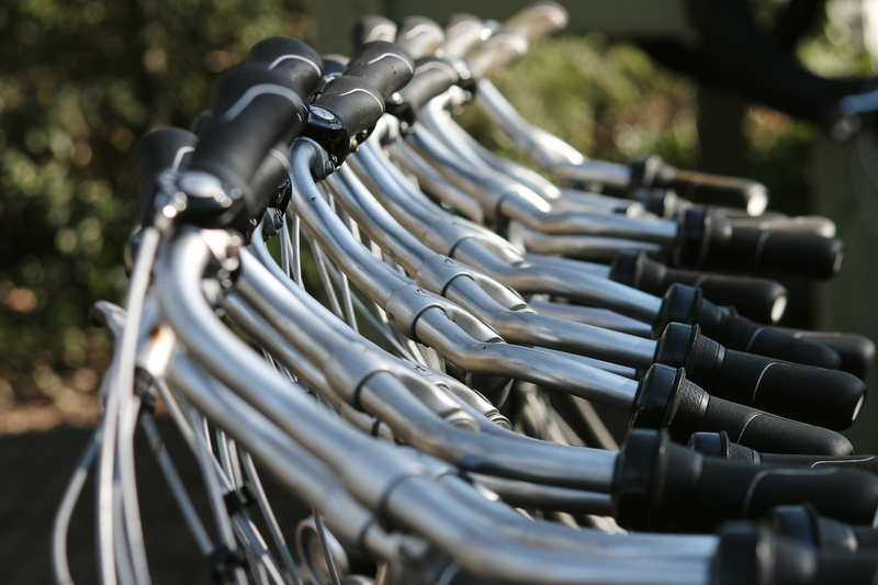 turned off, silver colored, metallic, chrome, means of transport, sport, mode of transportation, bicycle, sunlight, bicycles, side by side, day, rental