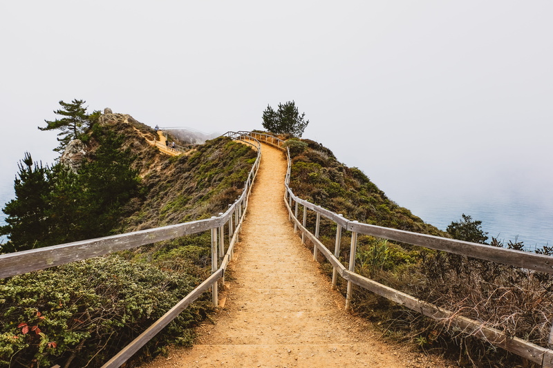 road, beauty in nature, outdoors, pathway, fog, nature, scenics - nature, direction, hill, daylight, plant, fence, diminishing perspective, footpath, no people