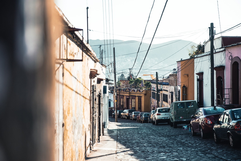 residential, row, cobblestone, lane, transportation, alley, outdoors, cars, motor vehicle, land vehicle, power supply, way, street, vehicle, house, wheel