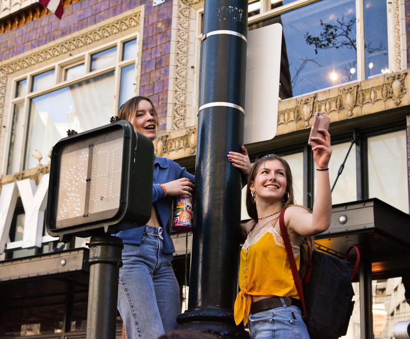two people, clothing, city, built structure, person, emotion, happiness, casual clothing, post, low angle view, sanfrancisco, portrait, march, sign, excited