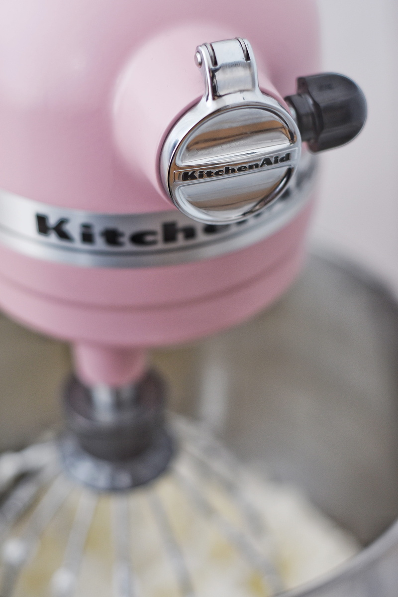 cylinder, batter, close-up, metal, trademark, cup, selective focus, indoors, machinery, coffee cup, stand, electrical device, still life, domestic room