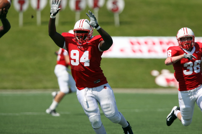 wearing, green, real people, sports team, red, man, sport, athletes, person, American football, players, stadium, clothing, helmets, field, game, white