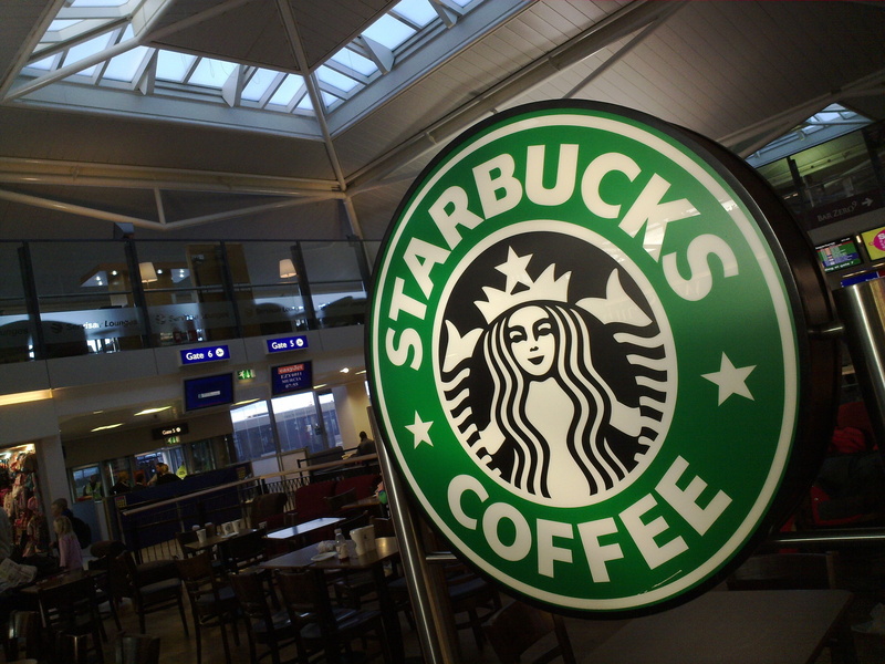 ceiling, sign, geometric shape, communication, illuminated, building, Logo, close-up, Starbucks, Wall, human representation, Coffee, day, no people, shape