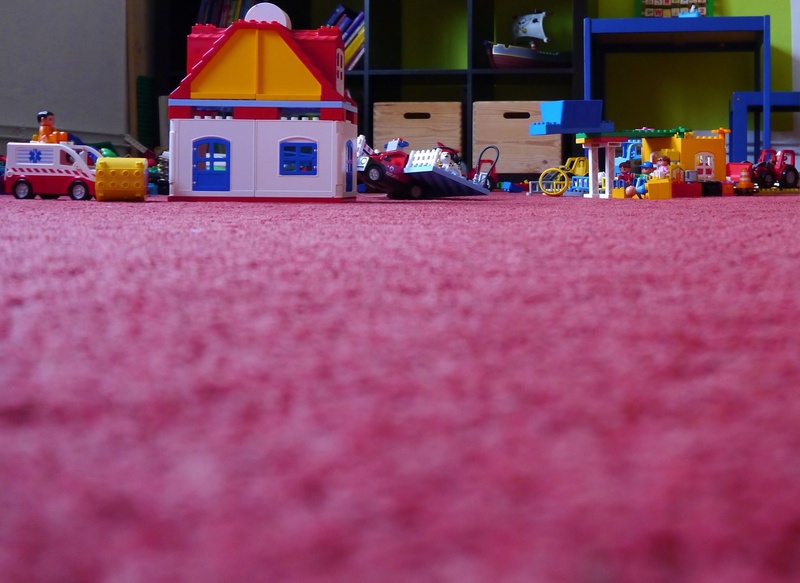 childrens room, street, group of people, men, toys, people, built structure, color, real people, city, building exterior, transportation, architecture