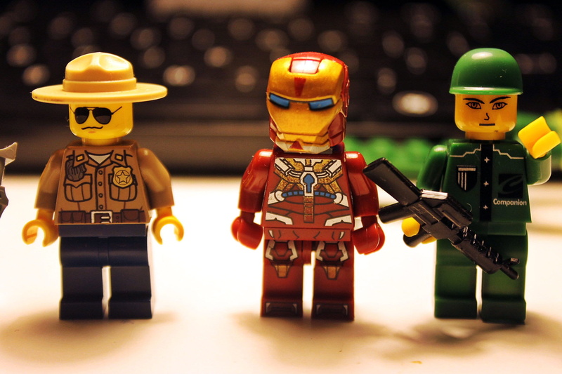focus on foreground, armed forces, lego blocks, indoors, pads, plastic, 1080P, no people, lego, figurine, cooperation, toys, futuristic, front view, representation