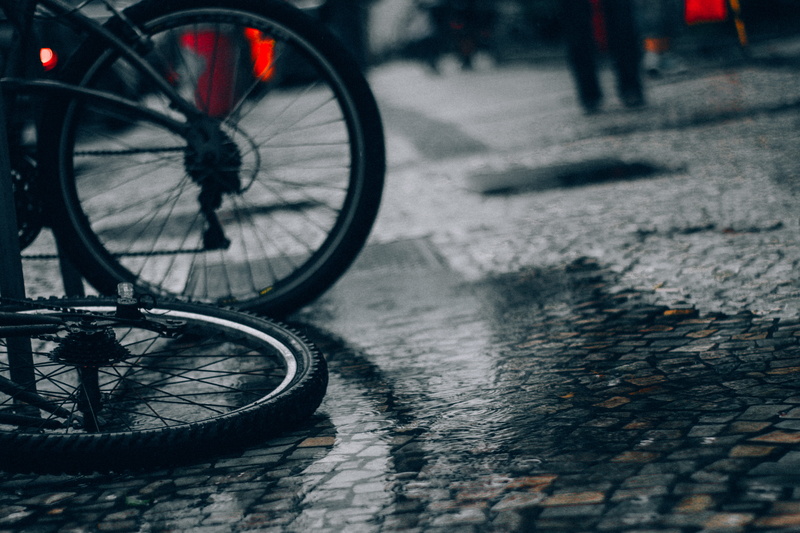 street, no people, outdoors, paving stone, bike, selective focus, brazil, stationary, rio de janeiro, transportation, rain, focus on foreground, 5K, land vehicle