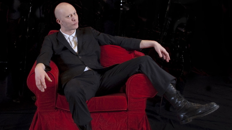 leisure activity, chair, males, mature adult, front view, black, formal, shoes, well-dressed, relaxation, bald, armchair, suit, red, s, mature men, three quarter length
