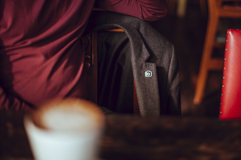 leisure activity, indoors, hand, selective focus, men, close-up, day, one person, jacket, holding, adult, human body part, formal, lifestyles, midsection