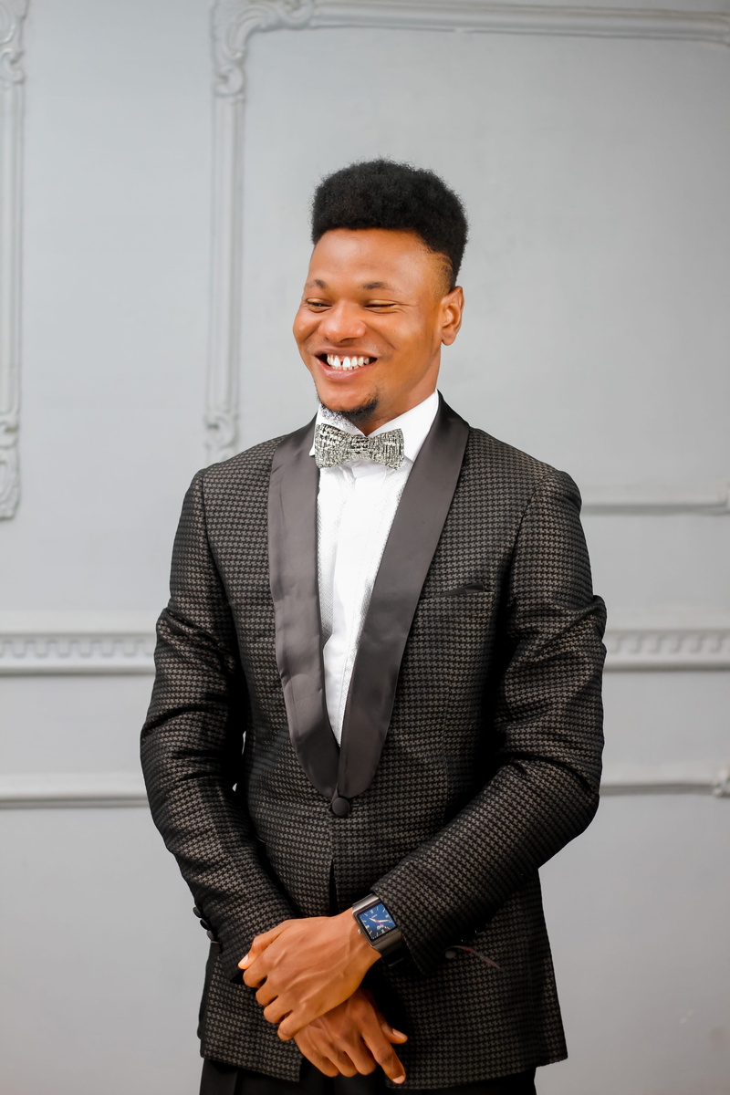 formal wear, tie, business, formal coat, front view, indoors, formalwear, male, standing, happiness, hairstyle, coat, bow, suit, 5K, bow tie, smile, teeth