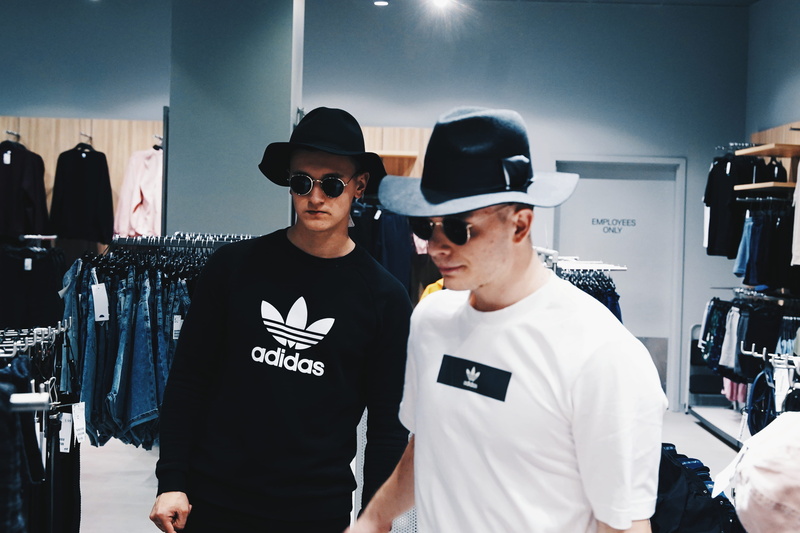 adult, t-shirt, casual clothing, accessory, hat, men, apparel, person, indoors, electronics, human, sunglasses, sleeve, shorts, fashion, baseball cap, real people
