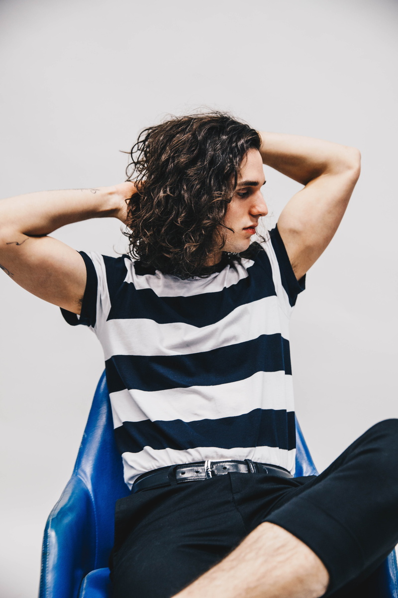 shorts, t-shirt, long sleeve, hairstyle, clothing, three quarter length, studio shot, 5K, front view, leisure activity, hand, face, wall - building feature