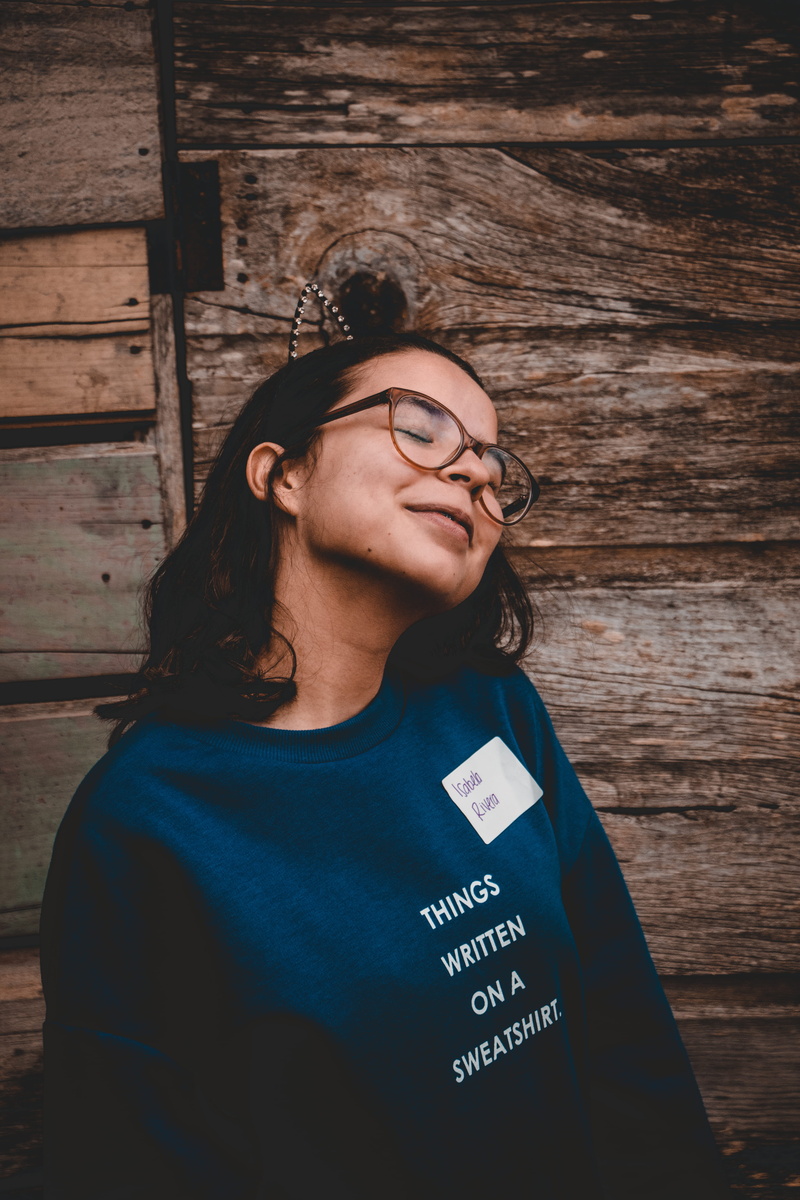 hardwood, lifestyles, trademark, standing, t-shirt, symbol, waist up, beautiful woman, real people, adult, accessories, human, female, young adult, apparel