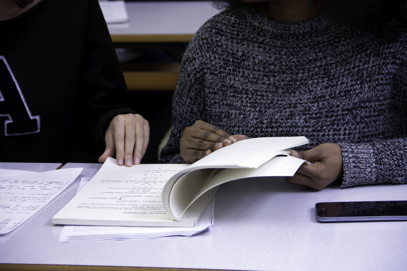 table, clothing, teamwork, indoors, real people, human hand, collaboration, page, book, occupation, hand, together, multiethnic, hands, coworker, midsection