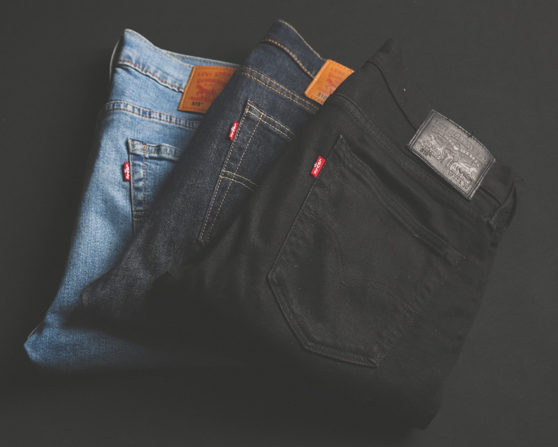 close-up, blue, pants, black background, blue jeans, 4K, denim, bag, black color, folded, high angle view, indoors, jeans, casual clothing, clothing, studio shot