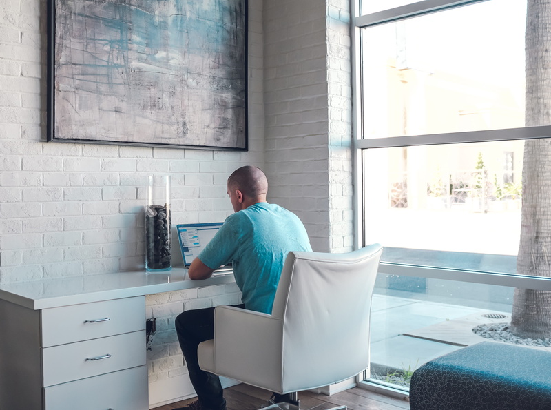 real people, work, remote worker, working remotely, contemplation, desk, using, rear view, glass, indoors, white, casual clothing, one person, seat, glass - material