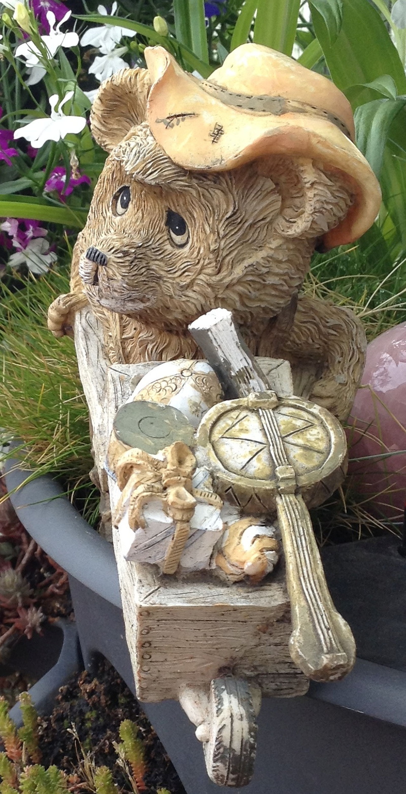 cart, animal representation, representation, sculpture, art and craft, plant, statue, toy, decoration, high angle view, mammal, bear, day, creativity, stone figure