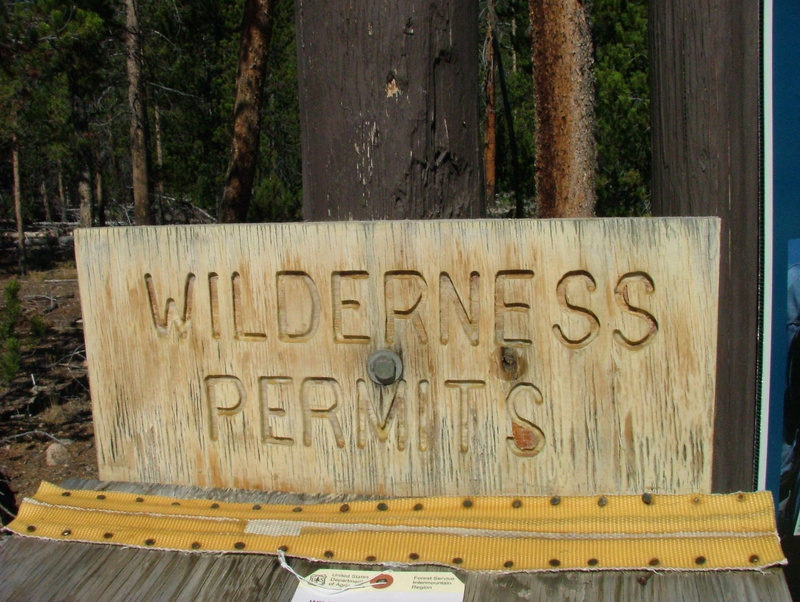 national park, text, hiking, tree trunk, plant, tree, sign, permit, communication, information, metal, capital letter, wilderness, information sign, nature