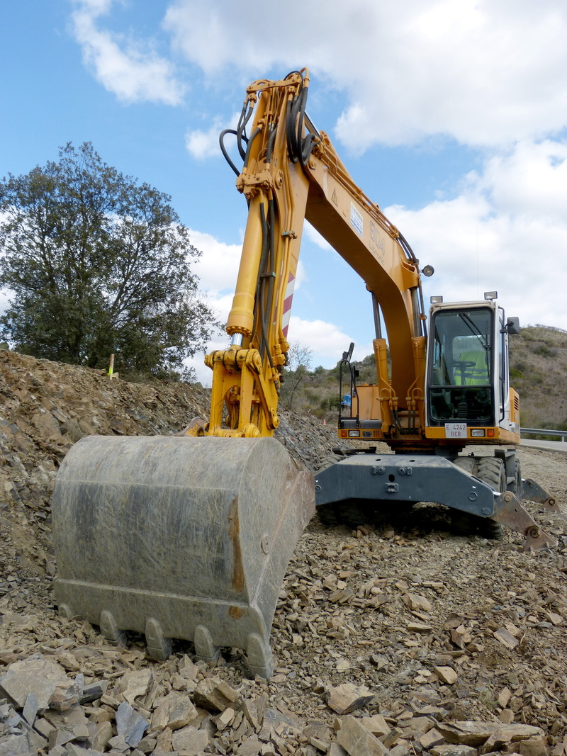 quarry, earth mover, land vehicle, machine, day, shovel, construction vehicle, gravel, transportation, construction site, industrial equipment, sky, bulldozer
