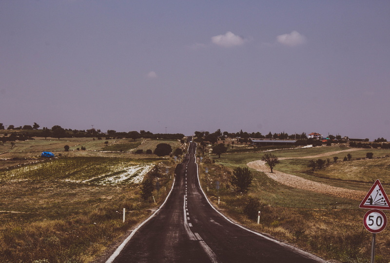travel, land, tranquil scene, highway, airport, transportation, sign, view, landscape, plant, field, outdoors, the way forward, gravel, scenics - nature