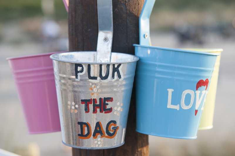 group of objects, outdoors, communication, label, focus on foreground, disposable, container, metal, recycling, fun, Beach, environment, western script