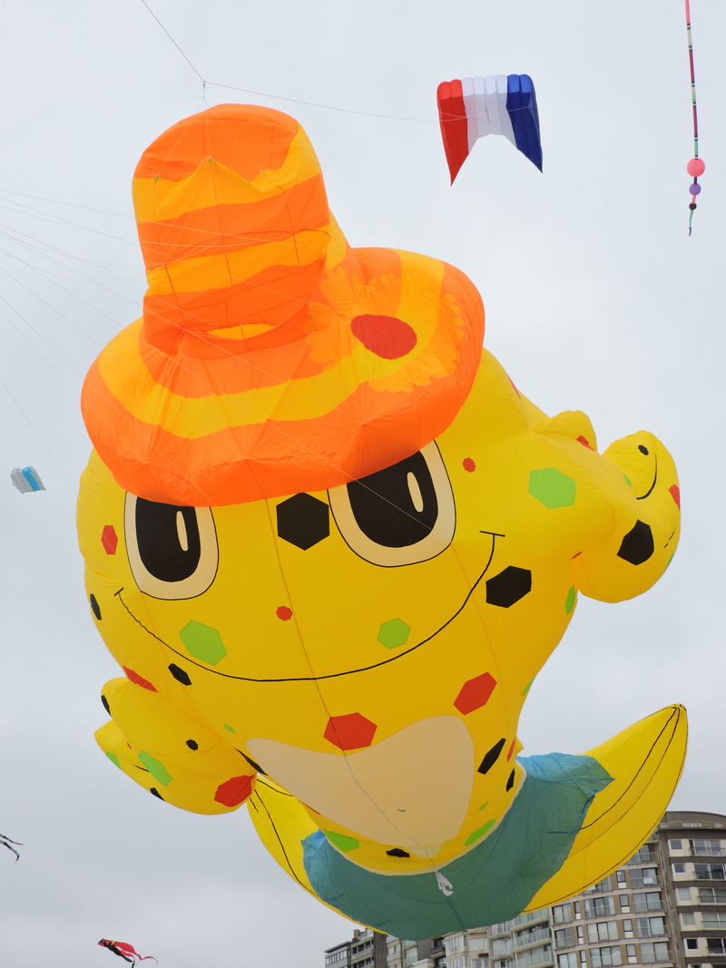 multi colored, mid-air, no people, sky, focus on foreground, representation, sea, nature, kites, art and craft, balloon, flying, low angle view, yellow