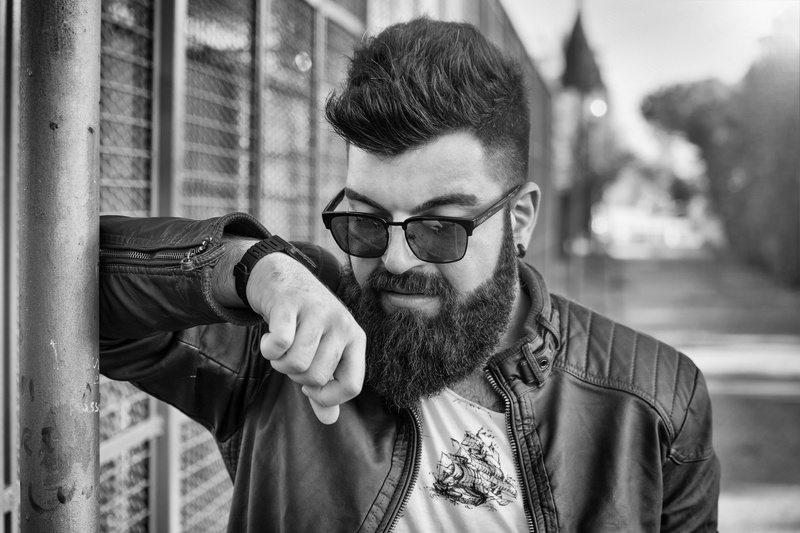 clock, one person, bokeh, males, focus on foreground, italian, glasses, face, young adult, outdoors, hair, lifestyles, sunglass, man, black and white, architecture